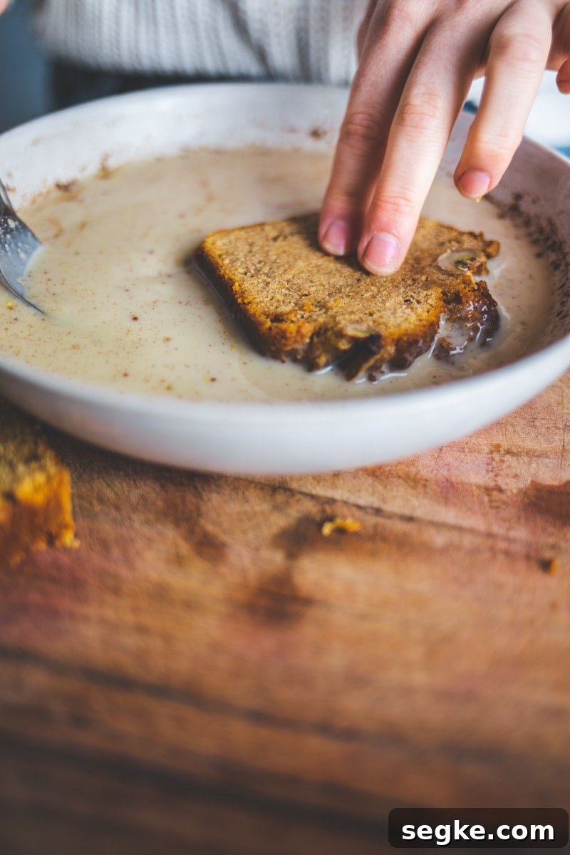 Banana Bread French Toast with Maple Syrup 2 Dipping the Vegan Banana Bread French Toast in flaxseed - Georgie Eats