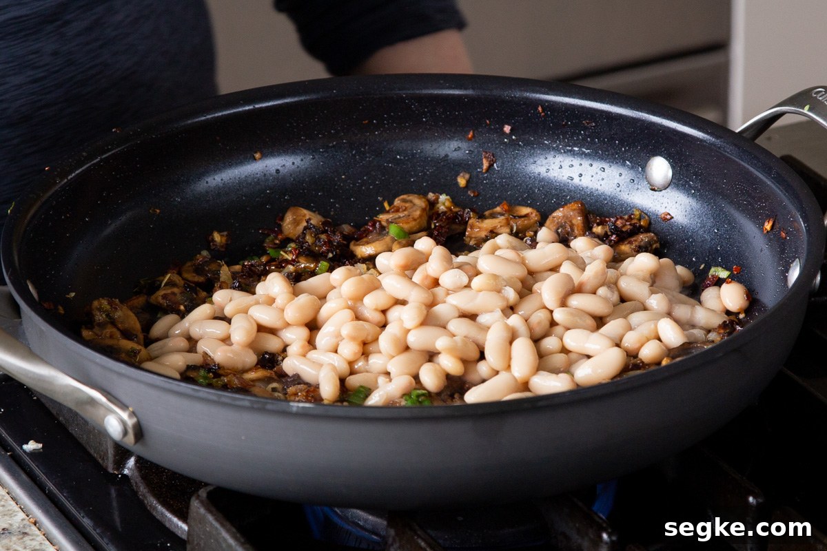 One-Pan Tuscan White Bean Skillet Recipe 10 adding white beans to the pan