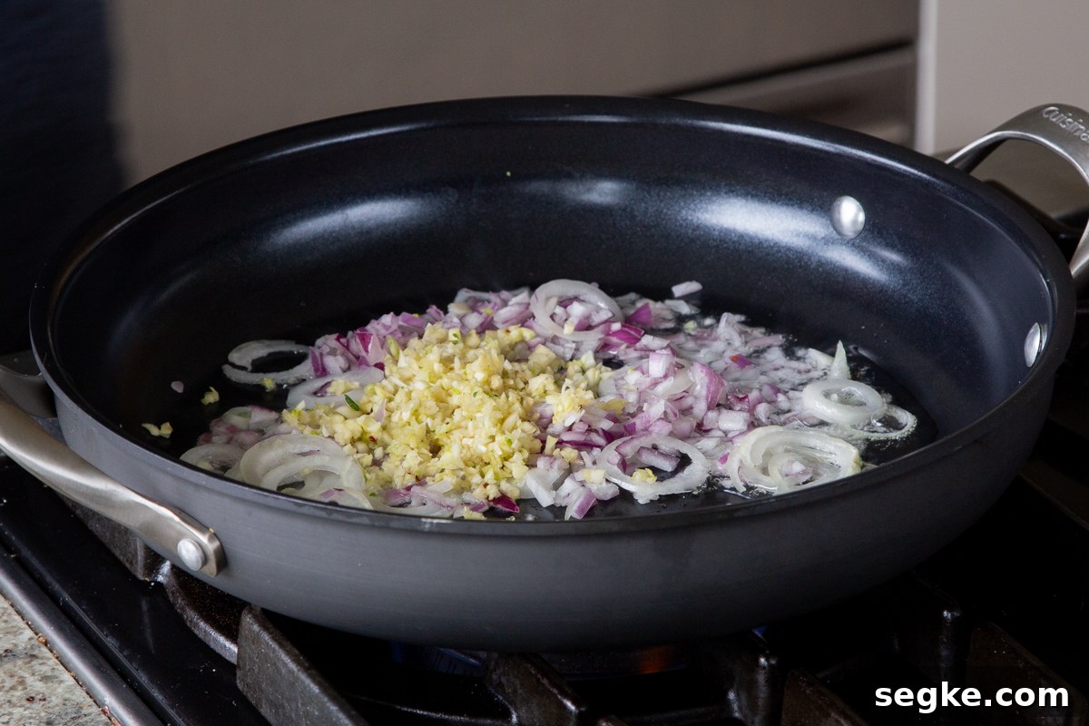 One-Pan Tuscan White Bean Skillet Recipe 5 garlic and onions in the pan, before cooking