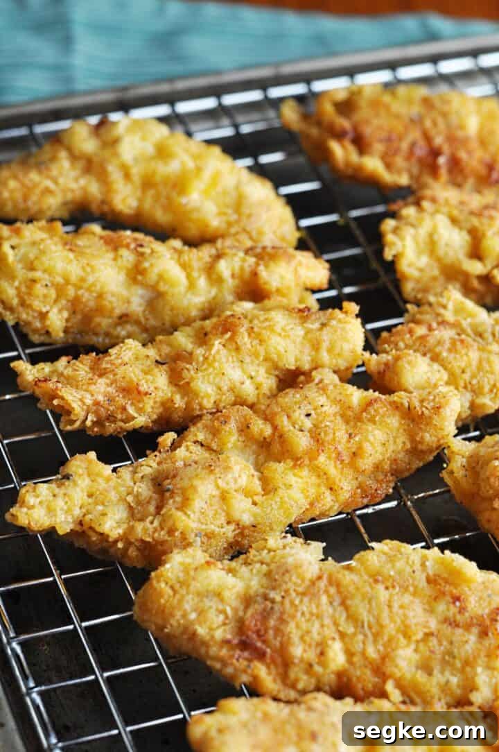 Crispy, Juicy Buttermilk Chicken Strips Recipe 5 Chicken Fingers Cooling on rack