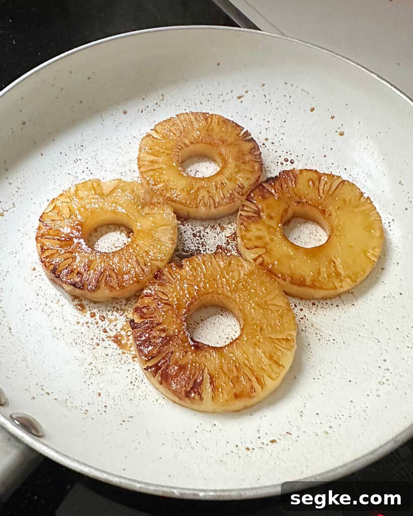 No-Bake Pineapple Cream Cheese Pie 9 White skillet with caramelized pineapple rounds.