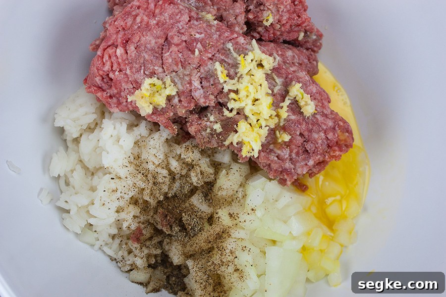 ground beef, rice, and seasonings for easy stuffed cabbage rolls in a white bowl