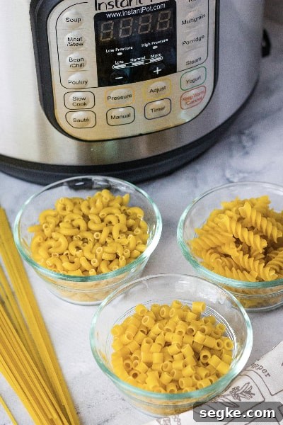 Instant Pot Pasta Recipe: Perfect Al Dente Every Time 3 three glass bowls of dried pasta in front of an Instant Pot