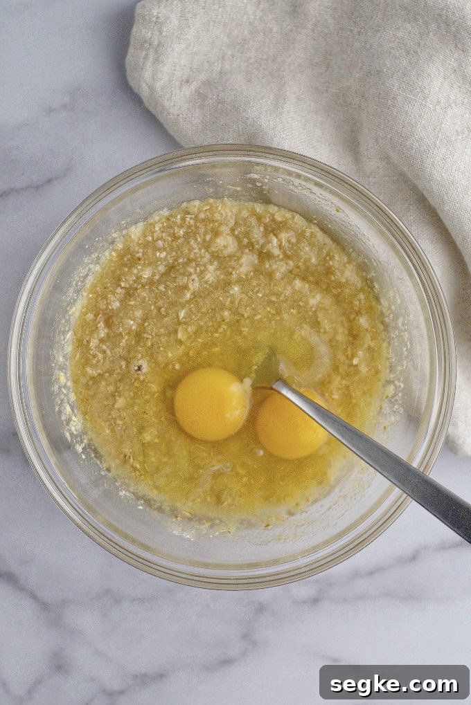 eggs added to filling in a mixing bowl