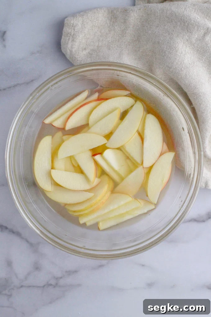 sliced apples in a citrus bath