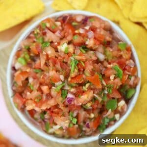 A bowl of homemade gluten free salsa with tortilla chips.