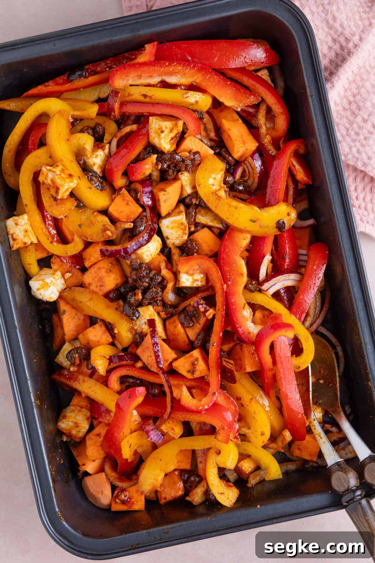 Sheet Pan Halloumi Tacos with Roasted Vegetables 7 Process shot for halloumi tacos recipe showing the halloumi taco ingredients mixed into the marinade before baking.