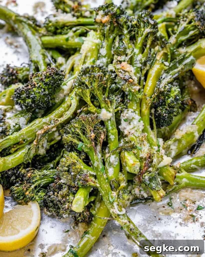 side shot of roasted broccolini on a pan 