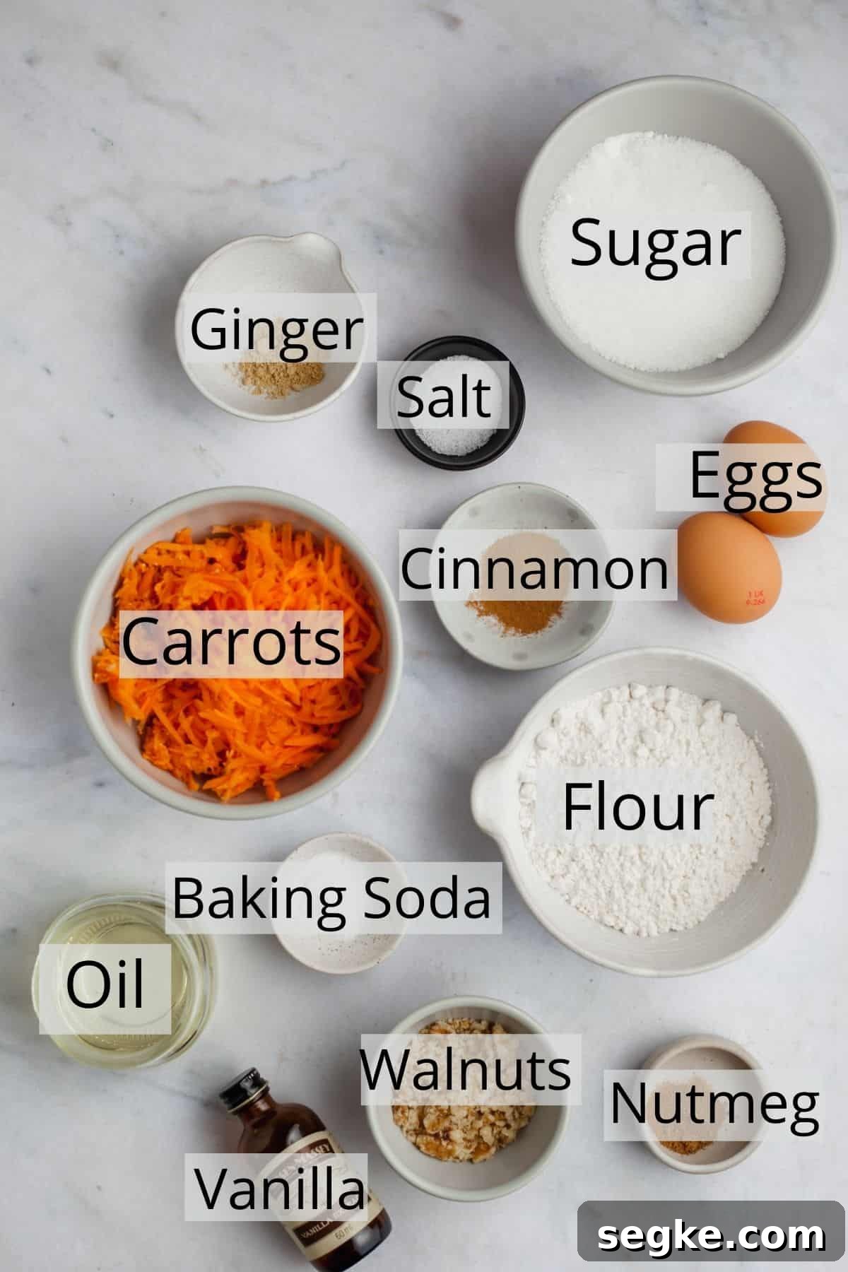 All the ingredients for carrot cupcakes weighed out in small bowls.