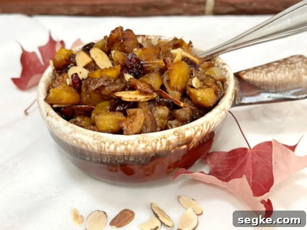 Sweet and savory roasted acorn squash with apples and onions in a rustic bowl — an easy, colorful fall side dish from GB’s Kitchen.
