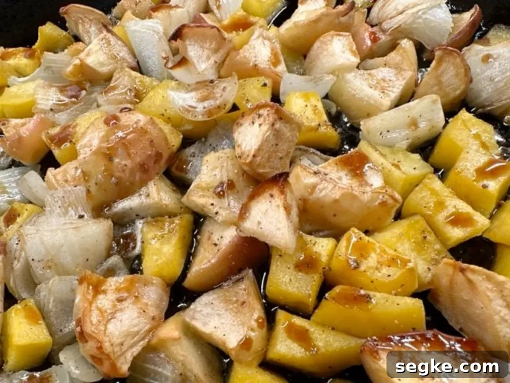 Golden roasted cubes of acorn squash, apples, and onions caramelized in the oven — sweet, savory, and full of fall flavor.