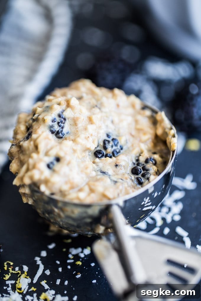 Up-close view of muffin batter in an ice cream scoop.