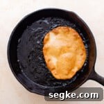fried elephant ears pastry in a cast iron pan.