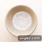 yeast mixture for elephant ears pastry in a ceramic bowl.