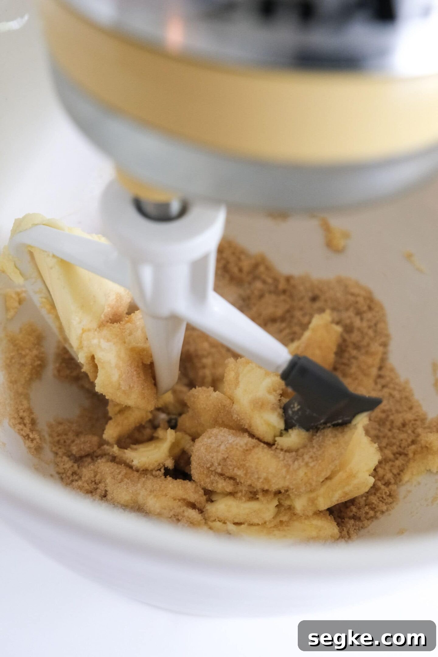 Combine brown sugar, white sugar, and shortening using a mixer at medium speed. Mix ingredients together until smooth.