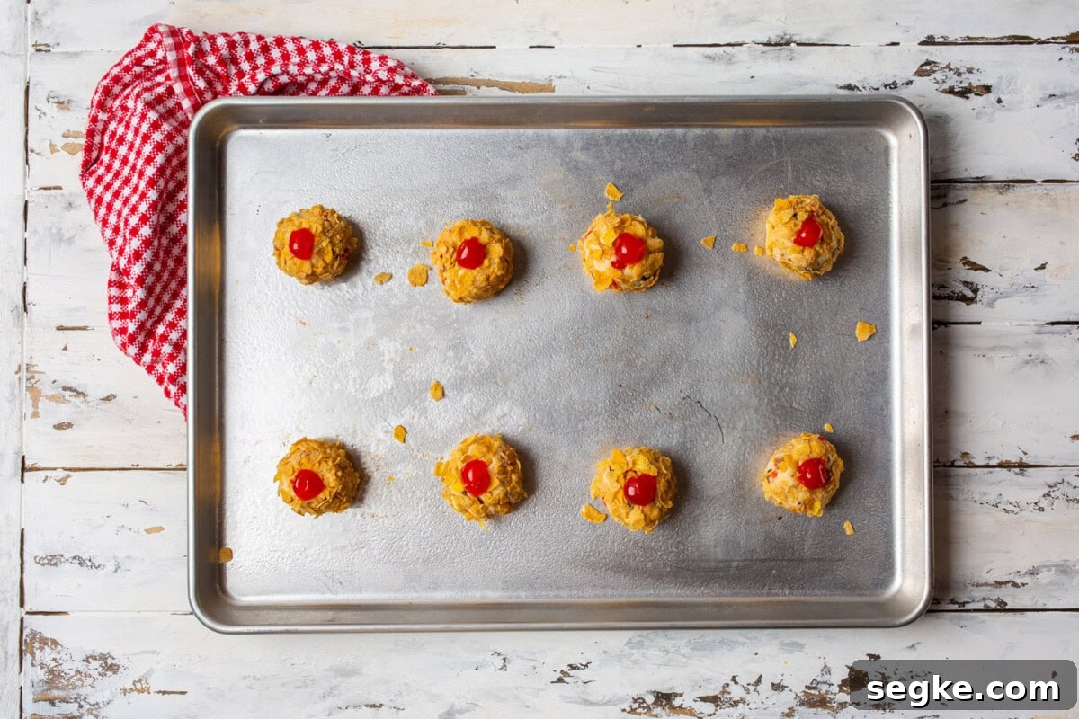 cherry wink cookie dough balls on a baking sheet