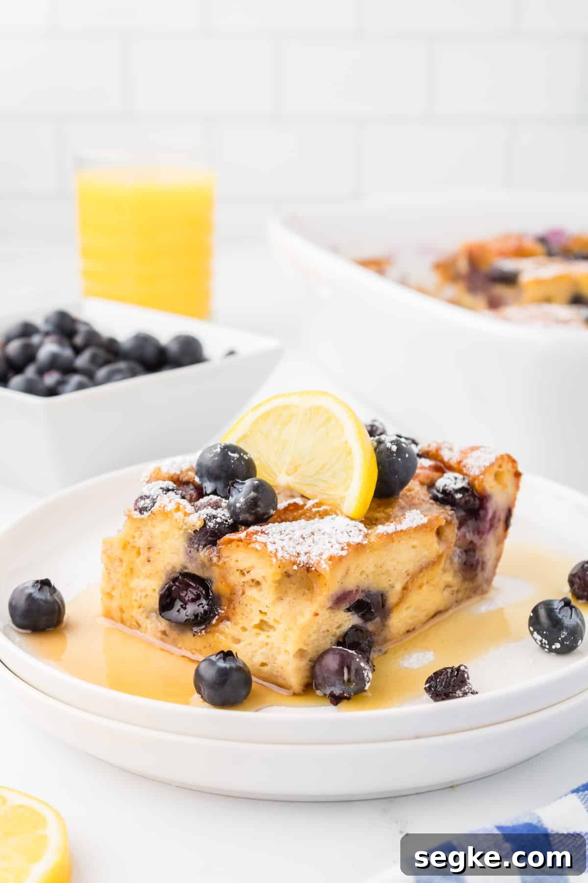 A slice of French toast casserole topped with blueberries.