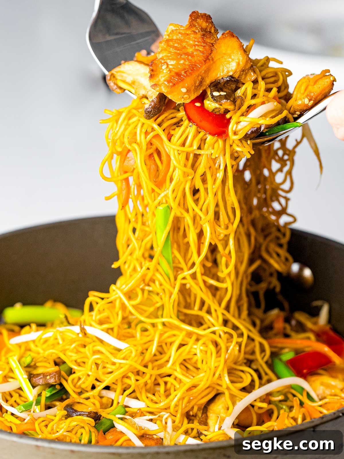 chicken chow mein noodles with vegetables served out of the pan