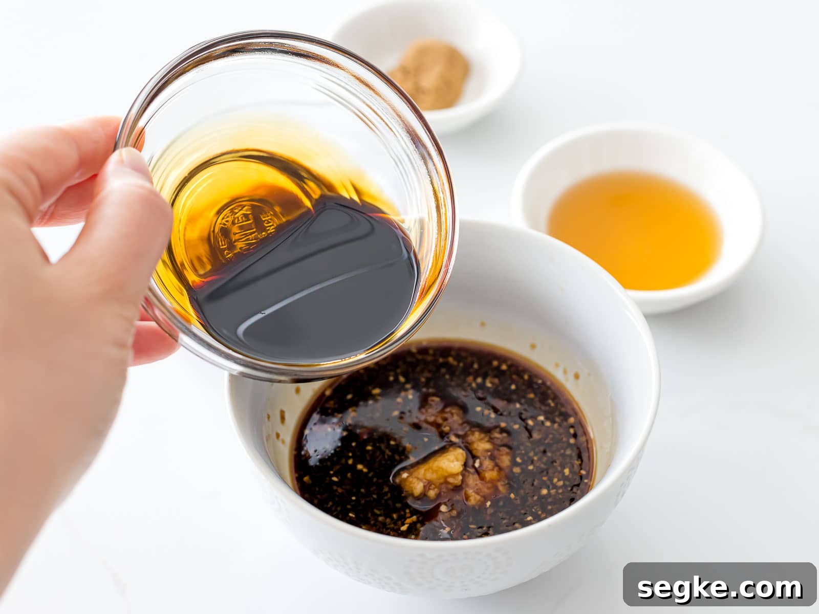 mixing soy sauce into a bowl of chow mein sauce