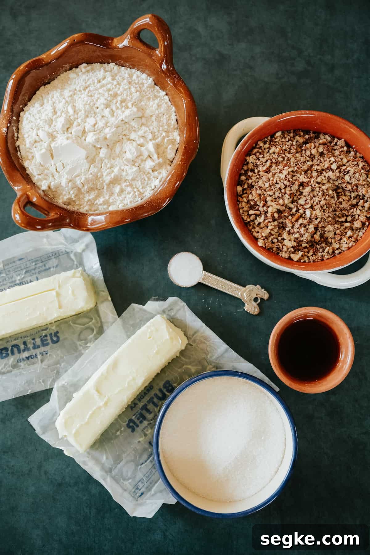 ingredients to make Polvorones Cookies (Mexican Wedding Cookies) - flour, pecans, butter, vanilla extract, salt, and sugar.