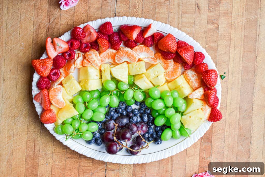 The strawberries are added to the platter with the rest of the fruit.