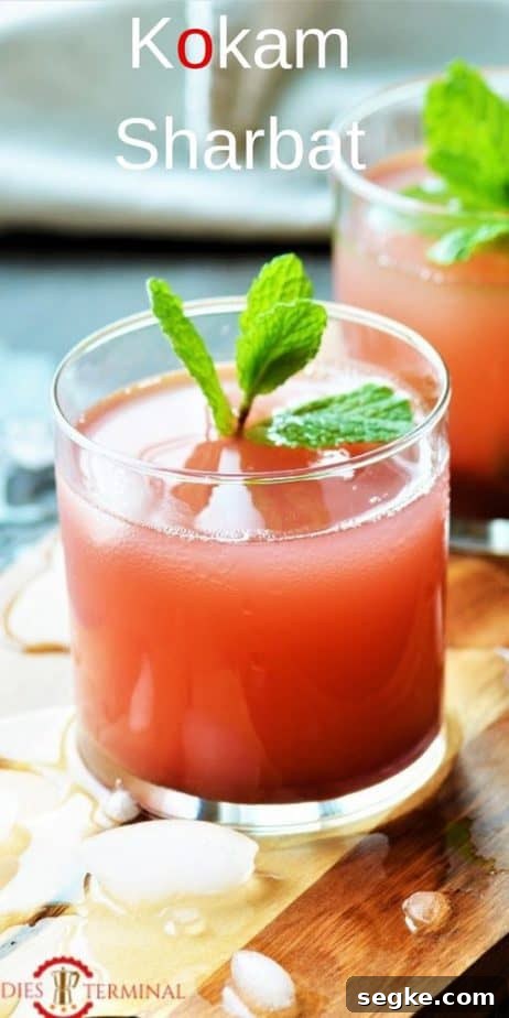 Kokam Sharbat chilled in glass kept on a chopping board with crushed ice