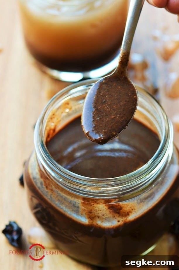 Kokum concentrate or Kokum syrup in a glass jar & a spoon