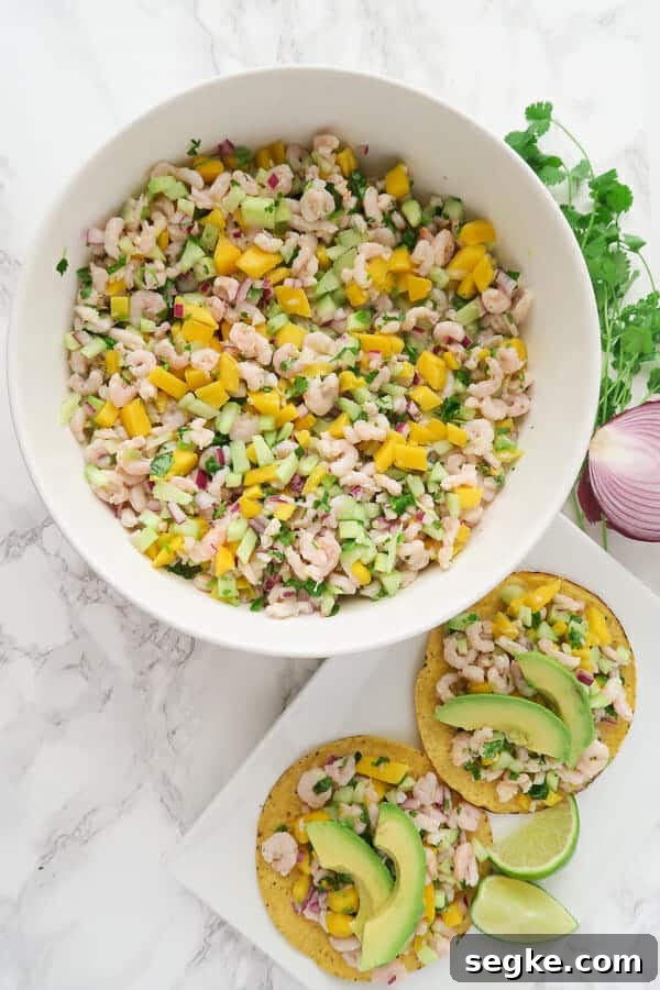 Shrimp Ceviche with Mango and Cucumber Recipe 2 overhead shot of a large bowl of shrimp ceviche and a plate of tostadas topped with shrimp ceviche and avocados