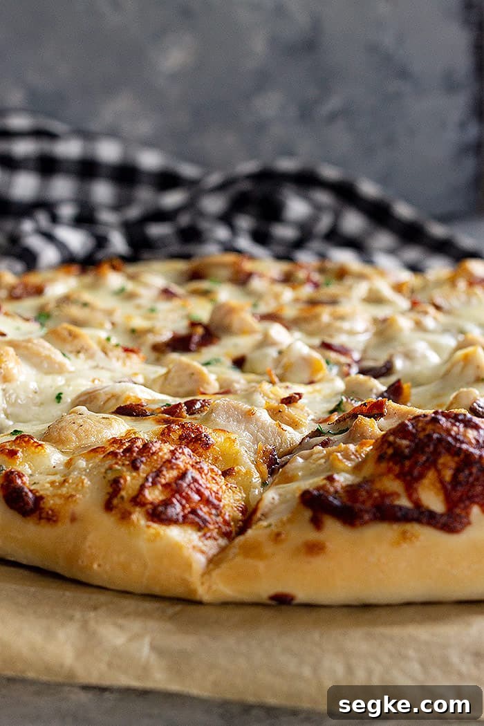 Crispy Chicken Bacon Ranch Pizza Recipe 2 Close up of pizza crust showing the lightly browned melty cheese.