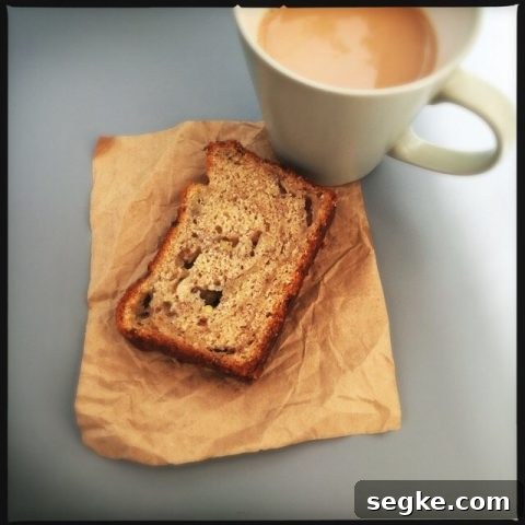 slice of banana loaf alongside a cup of tea.