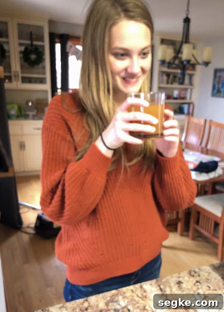 Two Holiday Recipes with a Modern Twist 8 A girl smiling and drinking apple cider punch.