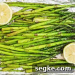 How to Smoke Asparagus: Tender, Smoky Grilled Spears 11 overhead close up of some smoked asparagus with some lemon on the sides.