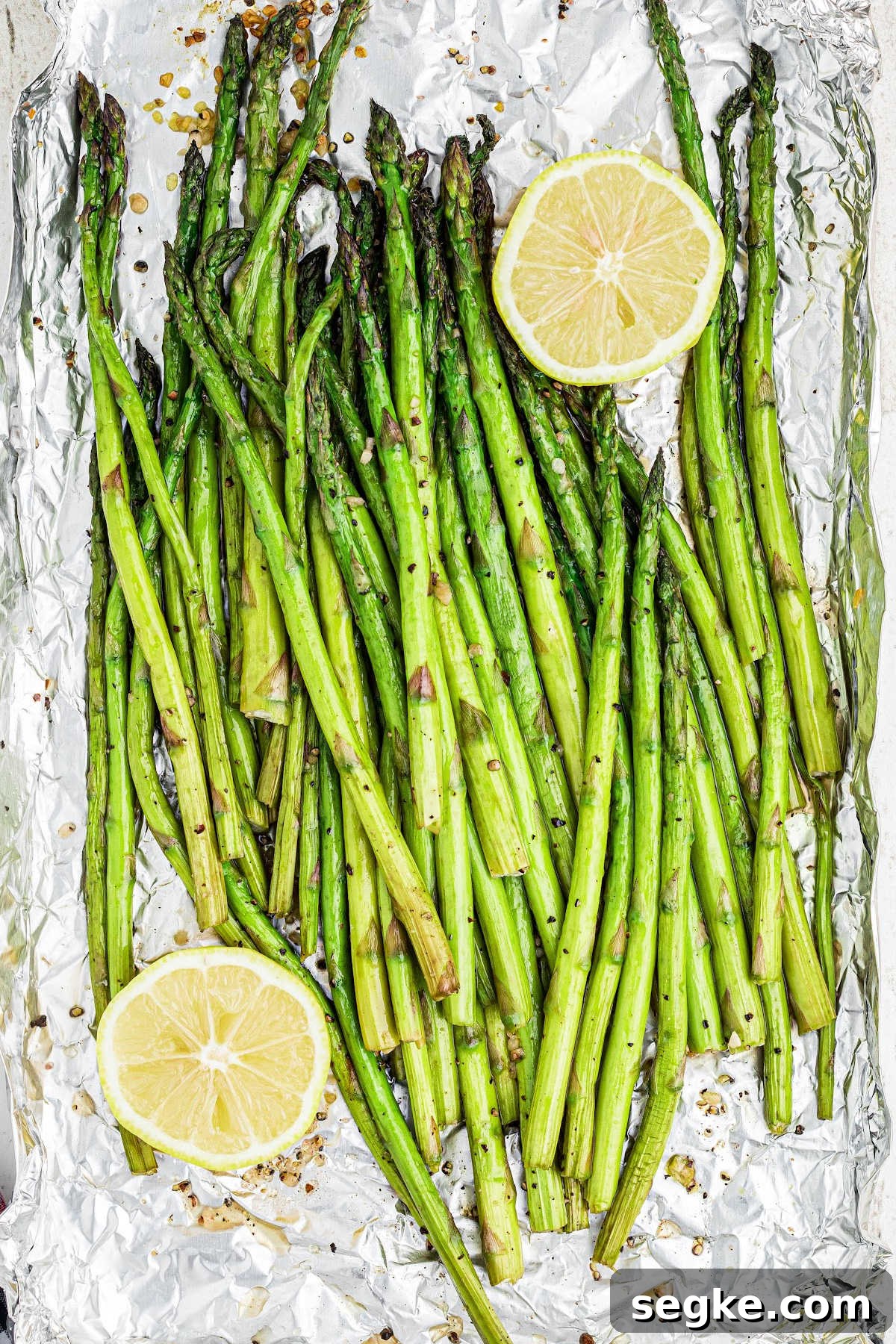 How to Smoke Asparagus: Tender, Smoky Grilled Spears 10 overhead close up of some smoked asparagus with some lemon on the sides.