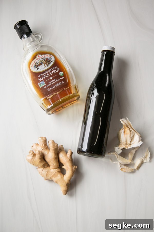 Homemade 5-Ingredient Gluten-Free Teriyaki Sauce and Marinade 2 ingredients for gluten-free tamari on the counter - maple syrup, tamari, garlic, ginger