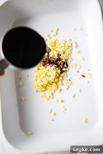 Homemade 5-Ingredient Gluten-Free Teriyaki Sauce and Marinade 3 pouring gluten-free soy sauce into dish with ginger and garlic