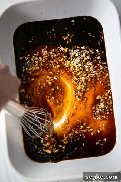 Homemade 5-Ingredient Gluten-Free Teriyaki Sauce and Marinade 4 hand whisking tamari into the ginger