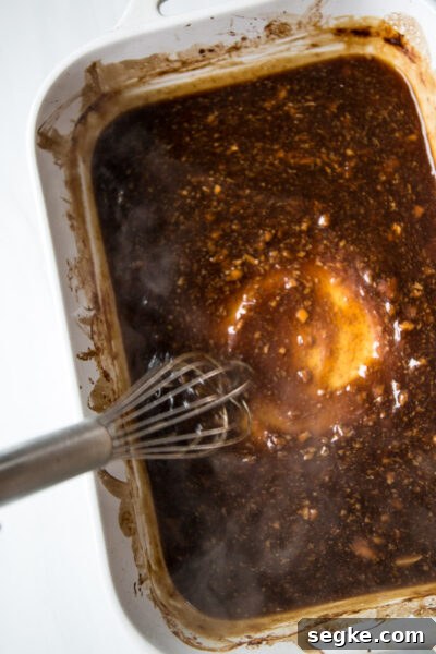Homemade 5-Ingredient Gluten-Free Teriyaki Sauce and Marinade 6 thickened gluten-free teriyaki sauce being whisked in a dish