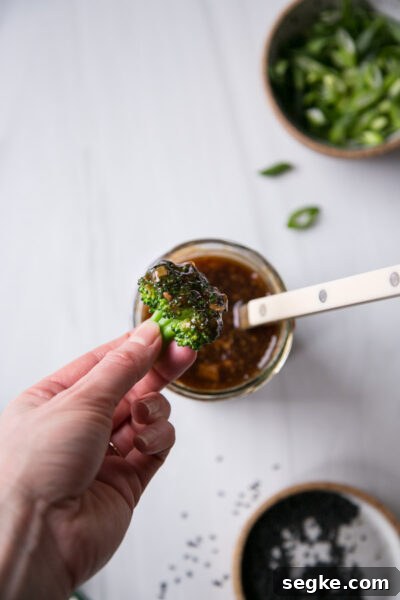 Homemade 5-Ingredient Gluten-Free Teriyaki Sauce and Marinade 8 hand holding broccoli floret dipped in gluten-free teriyaki sauce