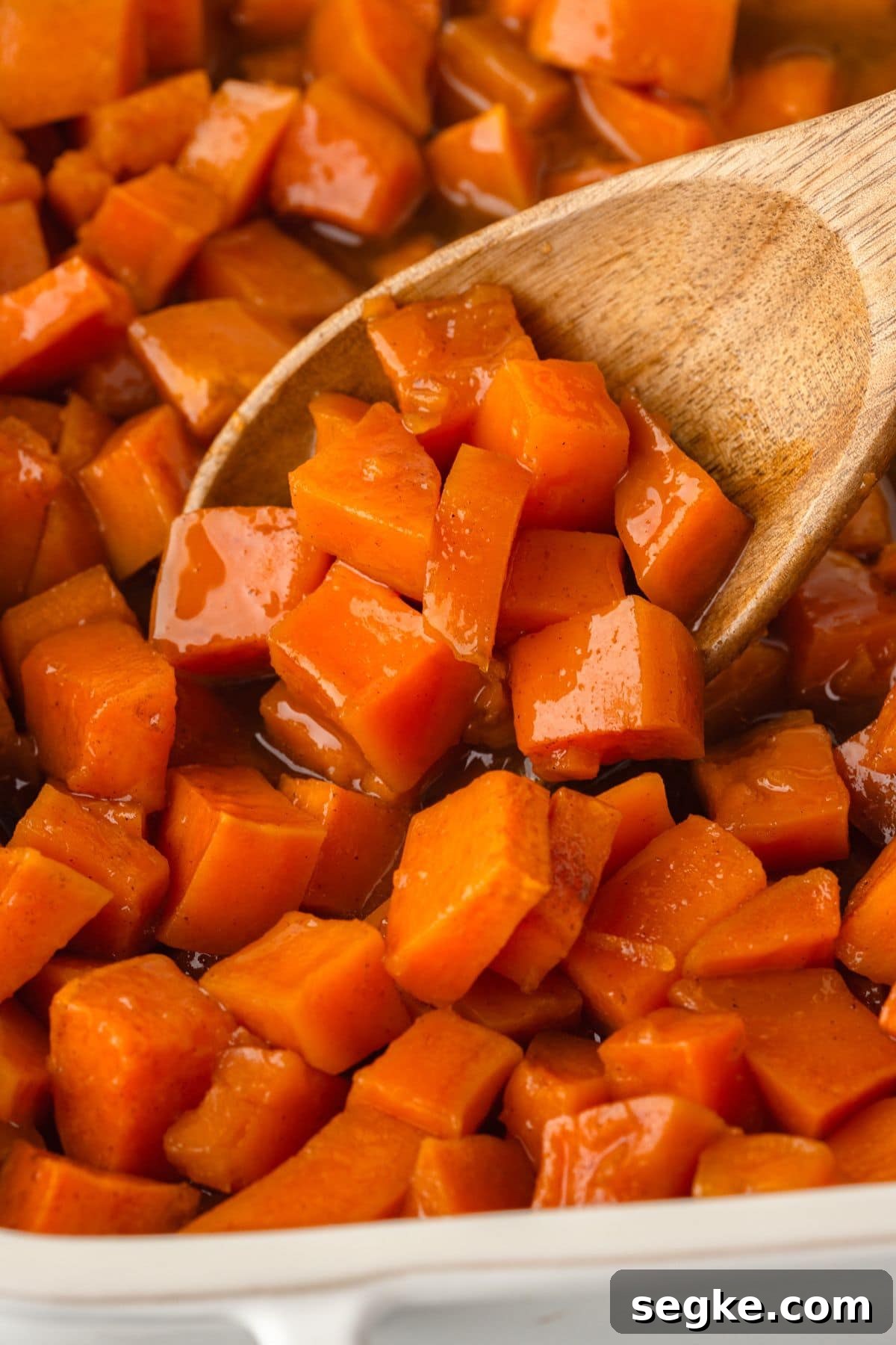 Candied Yams Recipe: Brown Sugar and Cinnamon Glaze 2 Sweet roasted sweet potatoes with caramelized edges in a baking dish.