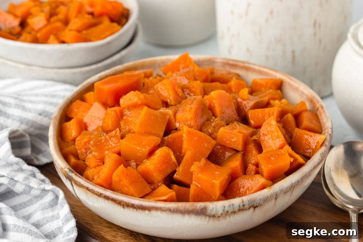 Candied Yams Recipe: Brown Sugar and Cinnamon Glaze 6 Roasted sweet potatoes in a rustic ceramic bowl for a healthy side dish.