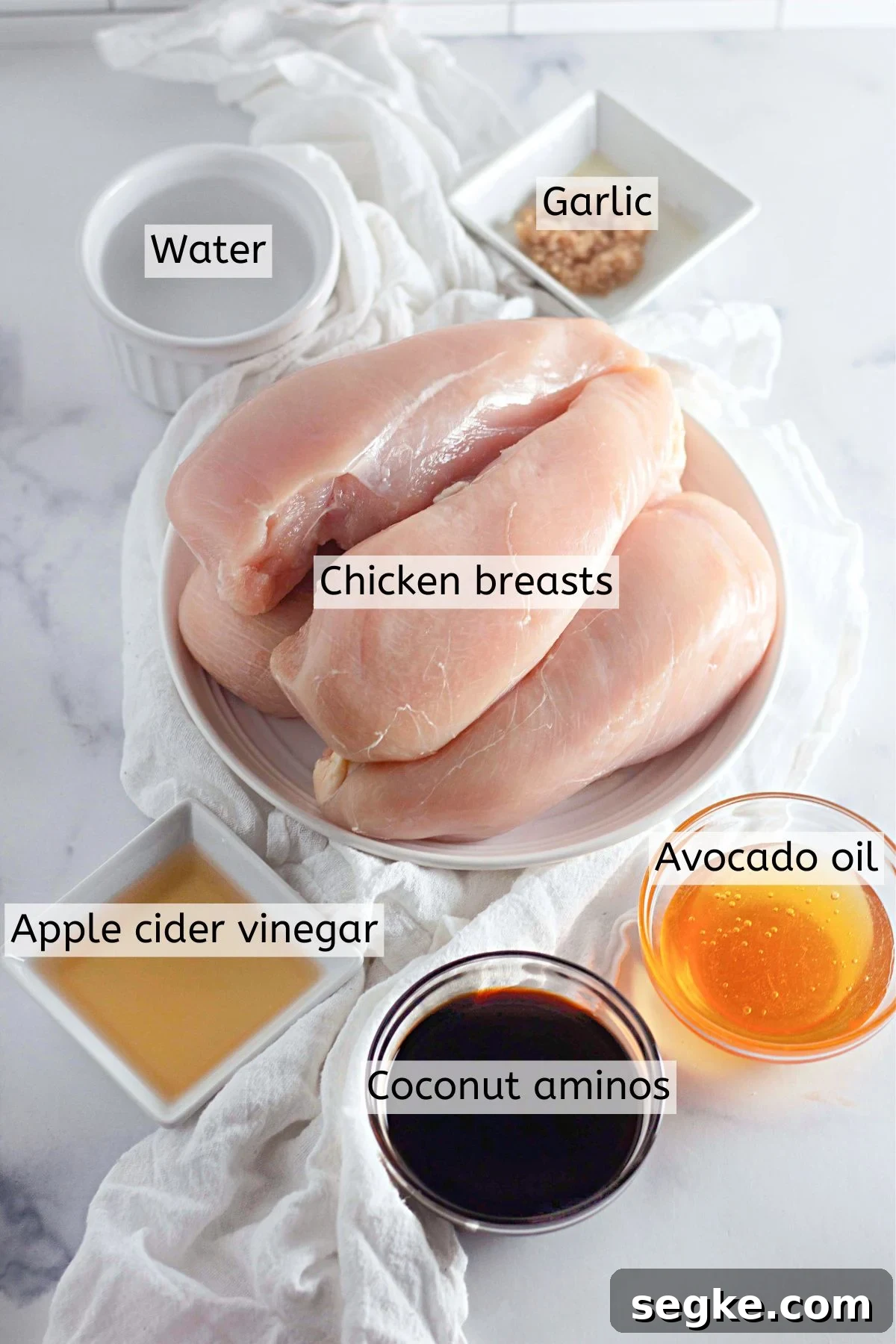 5-Ingredient Paleo Slow Cooker Chicken Recipe 3 Multiple ingredients like chicken, honey, soy sauce, and vinegar in bowls with text labels over top.