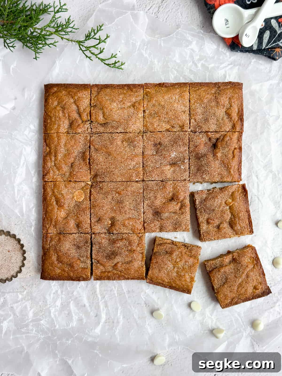 Gingerbread Blondies Recipe: Molasses-Spiced Chewy Bars 2 Gingerbread blondies cut into squares with some white chocolate chips around them.