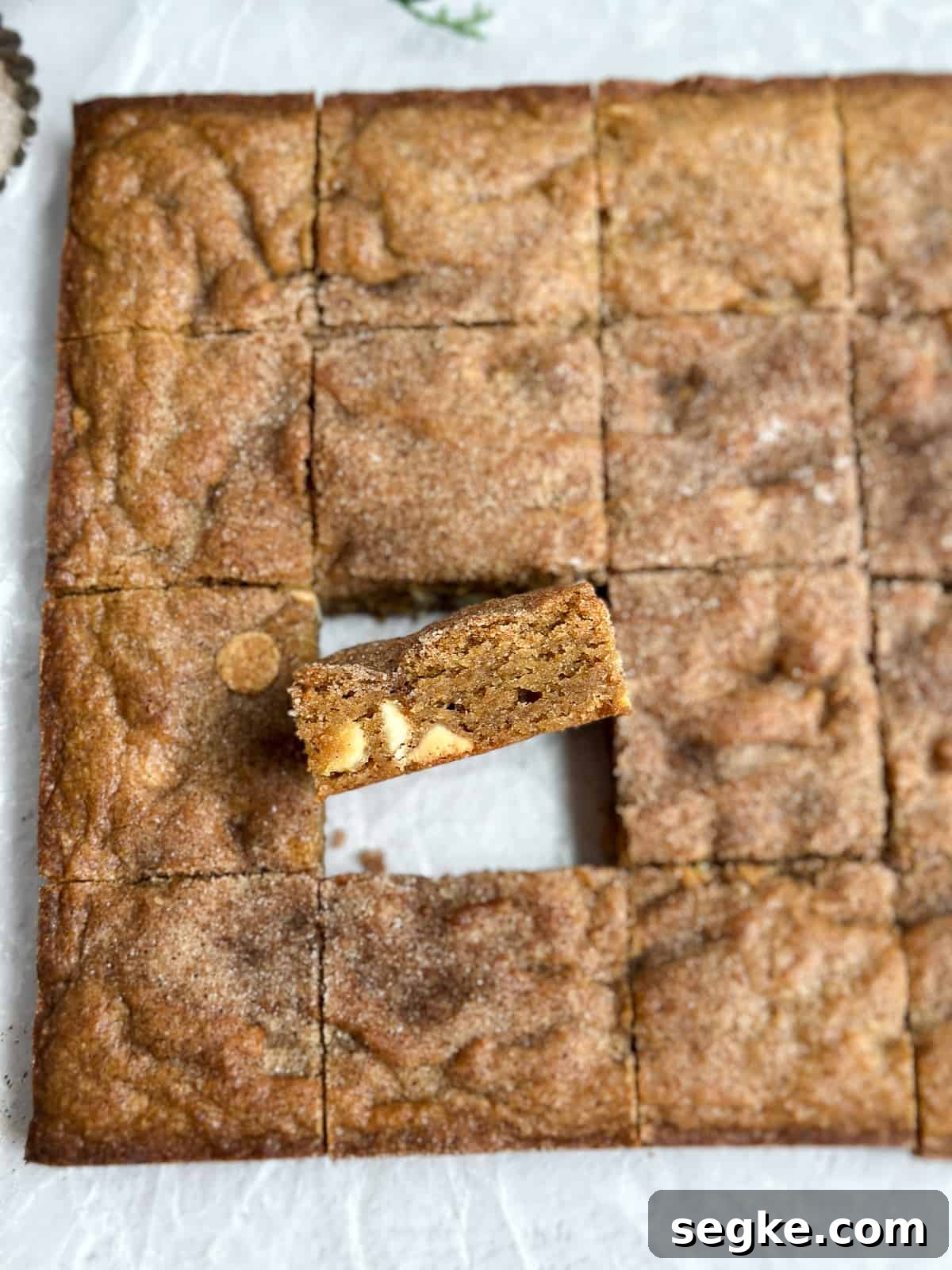 Gingerbread Blondies Recipe: Molasses-Spiced Chewy Bars 4 showing a gingerbread blondie turned up so you can see the white chocolate inside.
