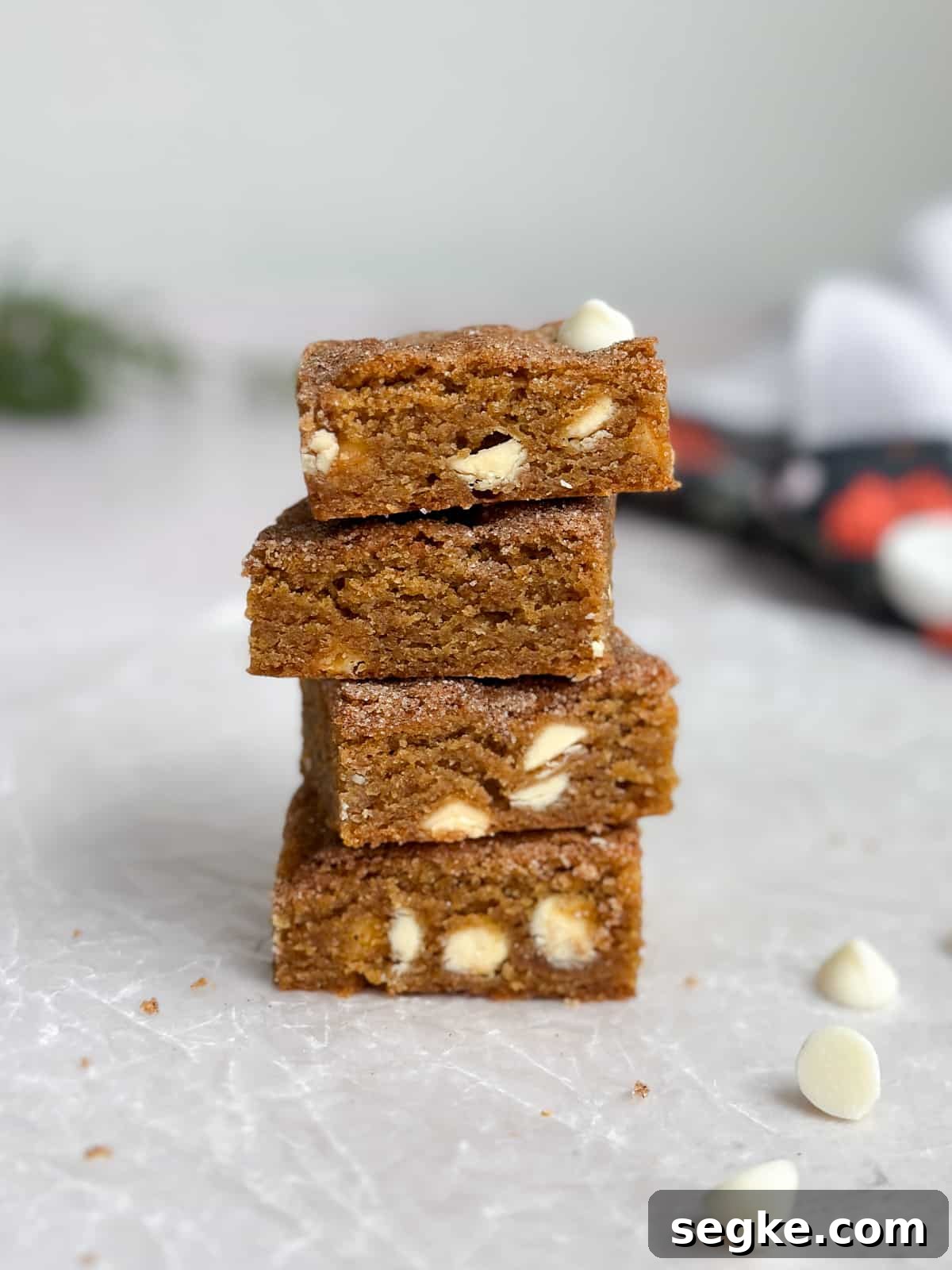Gingerbread Blondies Recipe: Molasses-Spiced Chewy Bars 7 4 gingerbread blondies stacked on top of each other to see the inside texture.