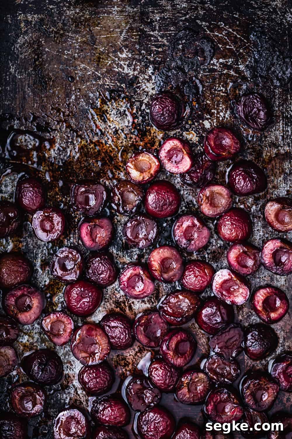 Roasted pitted cherries, on a cookie sheet, straight out of the oven.