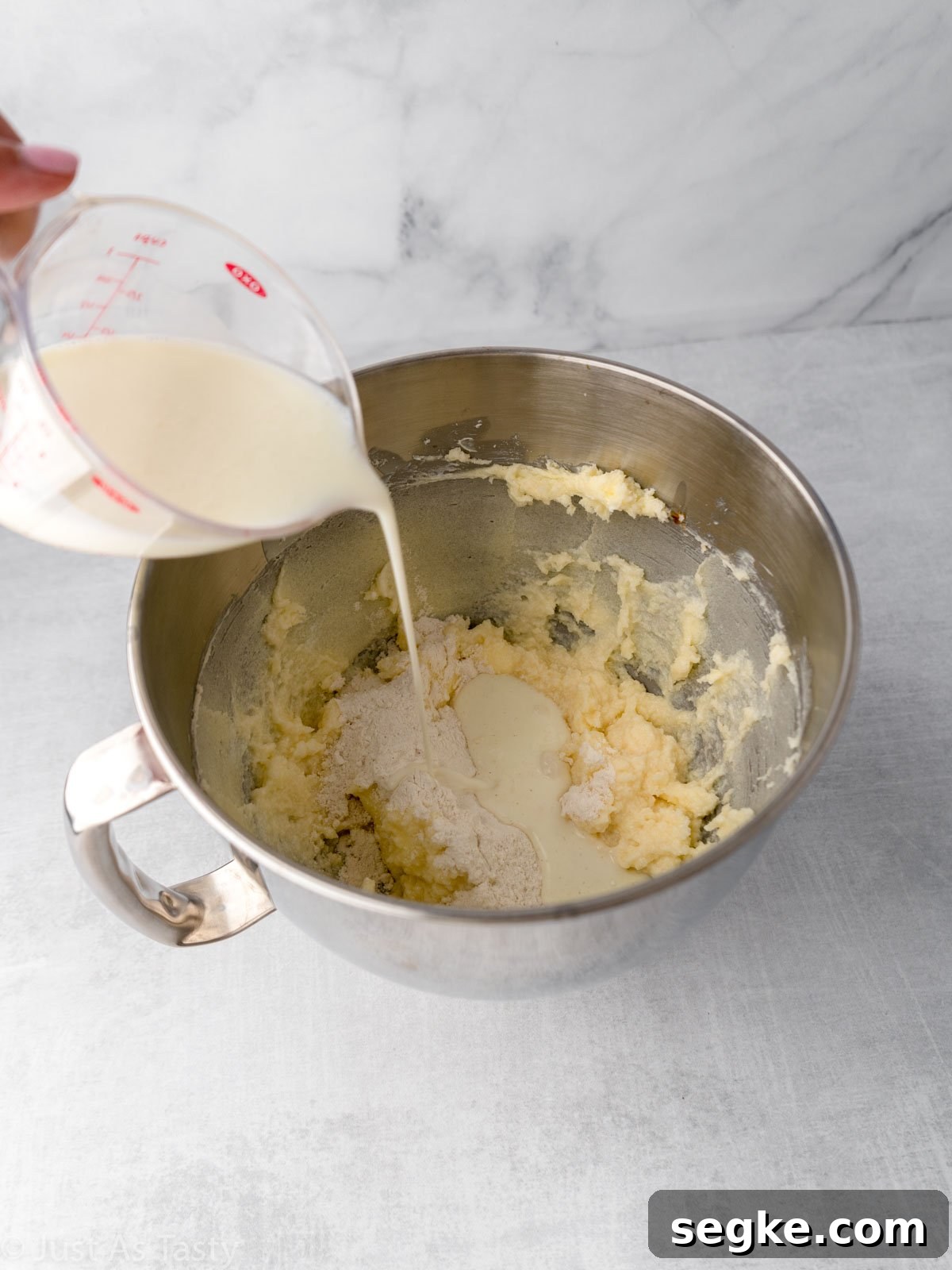 Moist Gluten-Free Coconut Cake Recipe 7 Buttermilk being poured into mixing bowl.