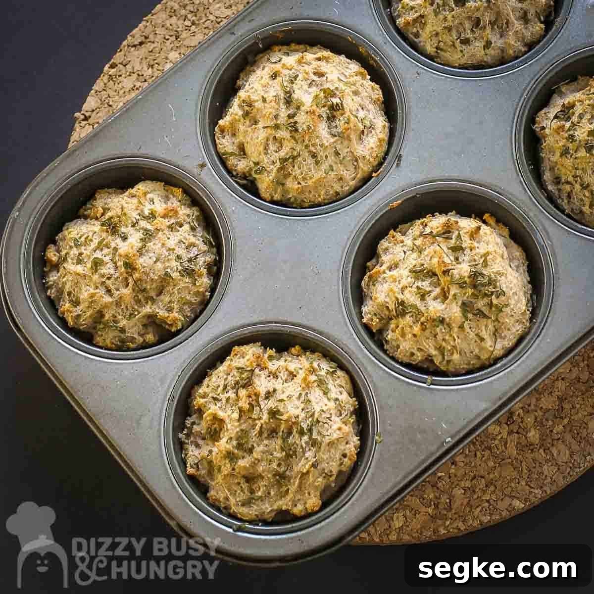 Flaky Mozzarella-Stuffed Whole-Wheat Biscuits Recipe 10 Overhead shot of biscuits in a metal muffin tin on a cork trivet.