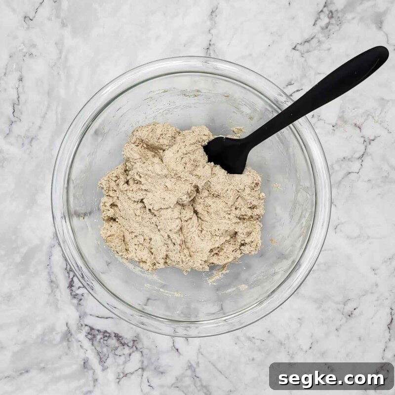 Flaky Mozzarella-Stuffed Whole-Wheat Biscuits Recipe 5 Overhead view of process shot 2 - in a separate bowl, combine the sour cream, canola oil, and water, and add the mixture to the dry ingredients and mix well.