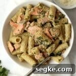 salmon pesto pasta in a bowl with parmesan