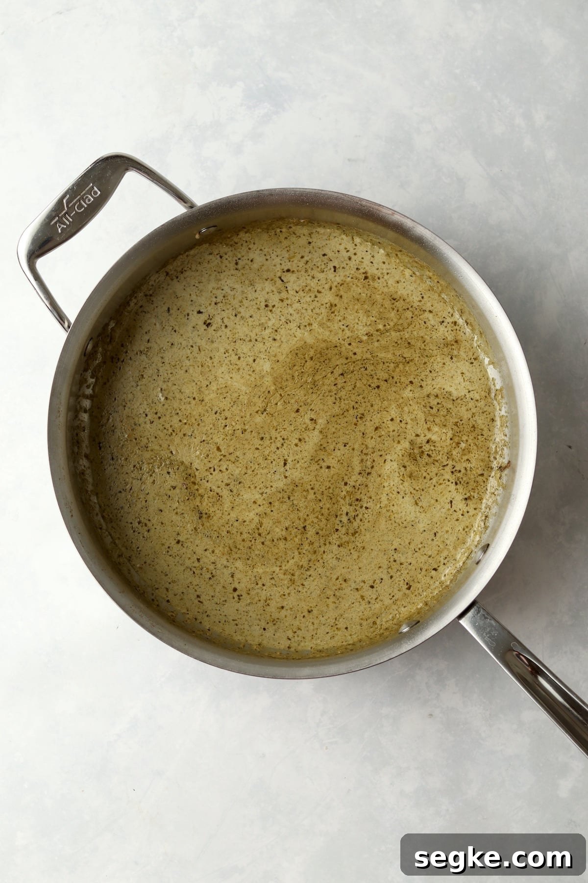 pesto cream sauce in pan.
